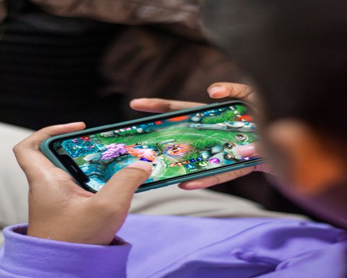 Angled smartphone showing the fictional Crown Grid Defenders team game